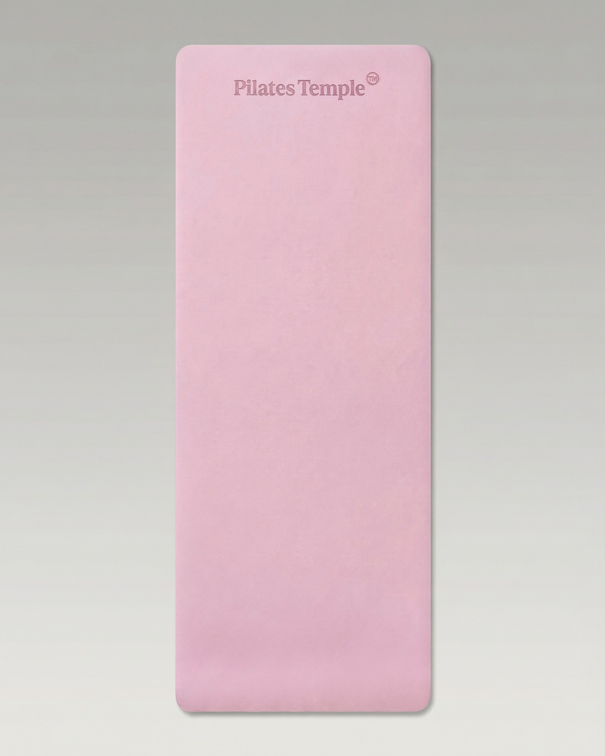 #color-Rose Tapis de Pilates antidérapant déroulé au sol.